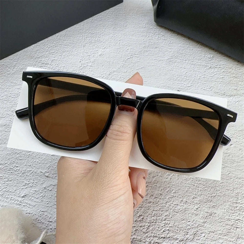 Stylish UV 400 Protective Brown Sunglasses with Black Frame for Men and Women - Classic Retro Fashion Eyewear.